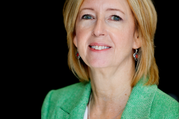 Head and shoulders of Dr Alison Campbell looking at camera and smiling. She has mid length blond hair and wears a white top and green jacket.